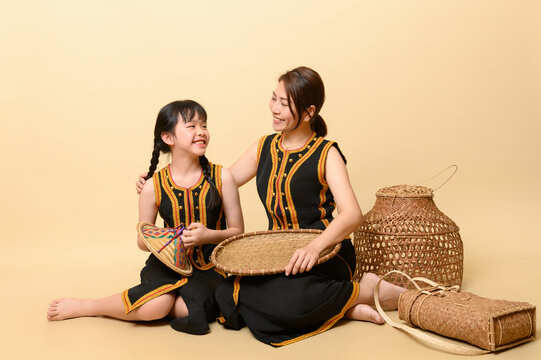 Beautiful kadazandusun native mother and daughter in traditional costume isolated in plain background