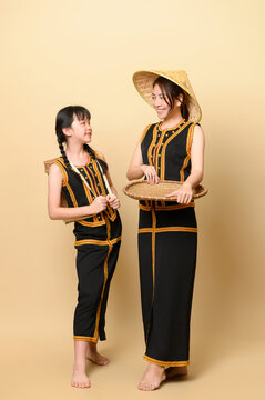 Beautiful kadazandusun native mother and daughter in traditional costume isolated in plain background
