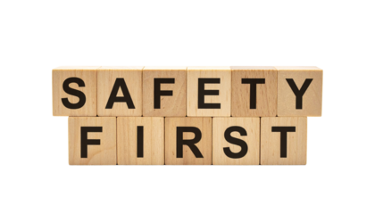 Wooden blocks display the words "SAFETY FIRST" in bold black letters.