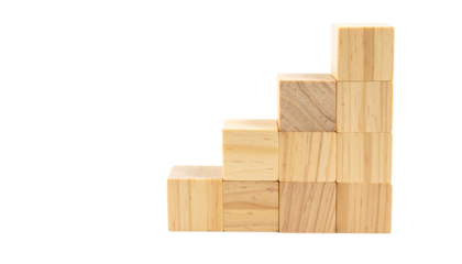Wooden blocks are stacked in a staircase formation, showing a concept of growth or progress.