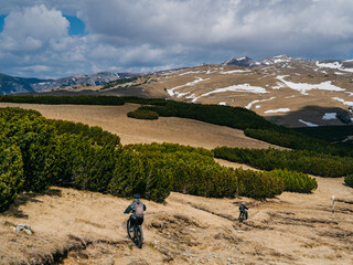 Bucegi Mountains plateau in Romania, showing a vast alpine landscape with scattered patches of snow...