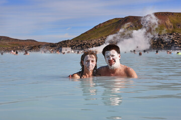 Couple enjoying blue lagoon geothermal waters. Iceland attraction landmark