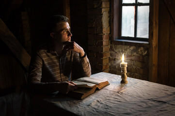Man at the table reading book