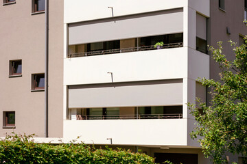 Balcony Roller Blinds of Modern Apartment Building. Outdoor Rolling Shutters Balcoly on Modern Building. Exterior Solar Protection.