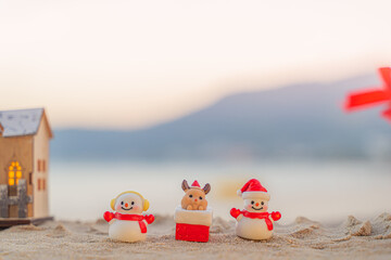 Santa Claus Doll Cute and Christmas Tree House Relaxing on the Beach. Merry Christmas Holiday. Bright Background. Patong Beach, Phuket, Thailand.