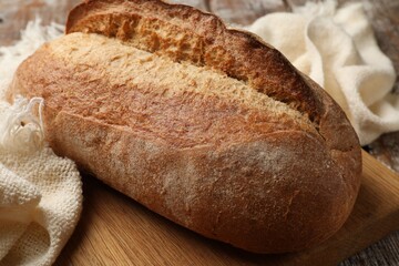 Fresh loaf of bread on table, closeup
