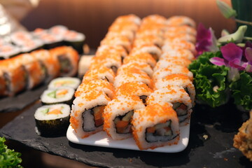 Sushi rolls platter Slow motion close-up of plated sushi rolls as white sauce is drizzled over top