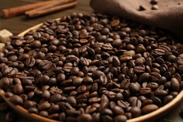 Aromatic coffee beans on table, closeup view