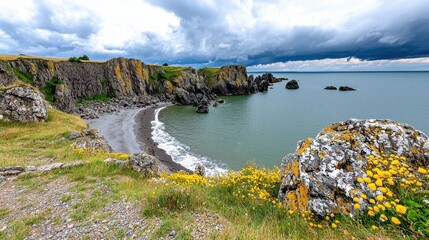 Obraz premium Dramatic Coastal Scene Dark Cliffs, Secluded Beach, and Cloudy Sky