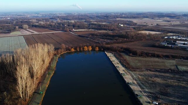 Tranquil landscape of Ub Serbia showcasing a serene lake surrounded by autumn trees and farmland