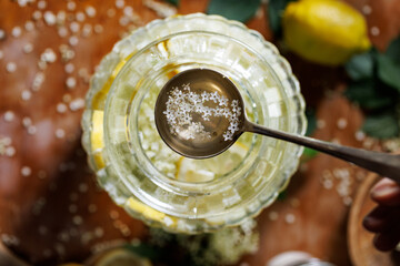 Close-up view of a ladle of elderflower syrup, top view