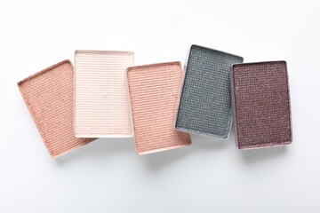Beautiful eye shadow refill pans on white background, flat lay