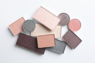 Beautiful eye shadow refill pans on white background, flat lay