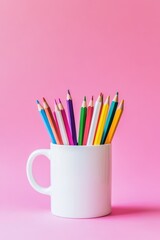 Colorful pencils in white mug on pink background. Vibrant art supplies for creative projects, school, or office use. Ideal for stationery and design themes.
