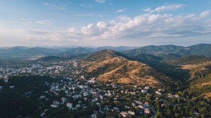 Obraz premium Panoramic aerial view of a European town nestled among rolling hills and mountains