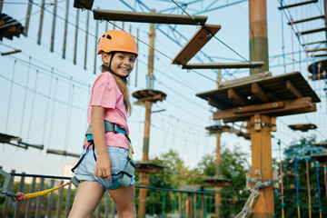 Preschool girl accuracy walking rope track enjoying extreme entertainment