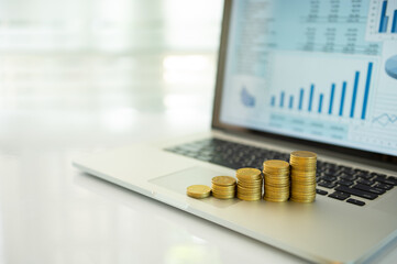 Money and long term investment for retirement portfolio on screen laptop. concept of savings, investment, retirement planning, personal financial planning.