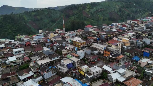 Aerial drone view of a small village town city in the rural hills mountains of east java indonesia