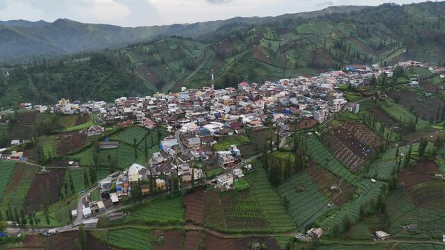 Aerial drone view of a small village town city in the rural hills mountains of east java indonesia