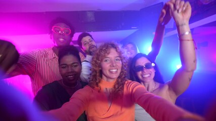 Diverse group of young friends capturing joyful selfie moment during energetic nightclub party, sharing infectious happiness and vibrant nightlife experience
