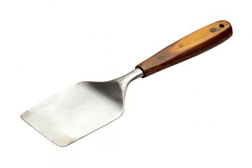 Vintage kitchen spatula with wooden handle and stainless steel blade for cooking and grilling isolated on a transparent background