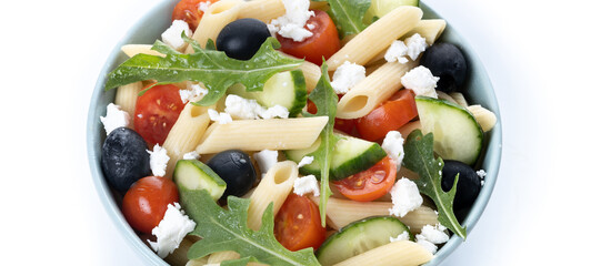 Mediterranean Pasta Salad in bowl with Fresh Vegetables and Herbs isolated on white background