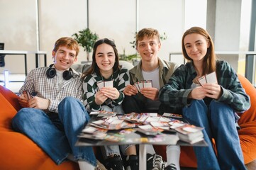 Group of students playing board game in a modern coworking space