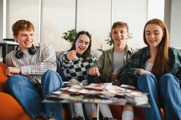 Happy friends playing board game at home