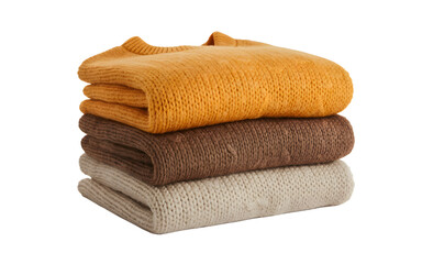 Stacked folded sweaters in warm autumn colors creating a cozy feeling and inviting warmth