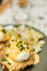 Poached egg with creamy sauce and chopped chives on a savory dish
