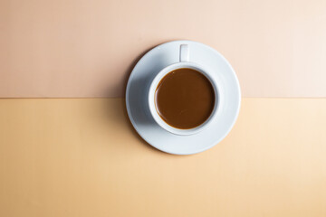 A cup of coffee on a white saucer