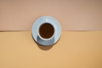 A cup of coffee on a white saucer