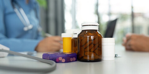 Health and Wellness. Various medication bottles on a doctor's desk for patient consultation.