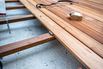 Wood deck construction with hidden fasteners during installation process