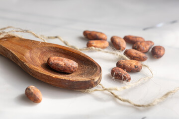 Scattered cacao beans and spoon