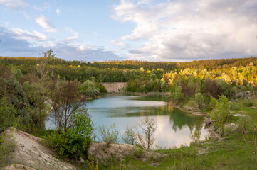 An abandoned white clay quarry. A lake in the mountains