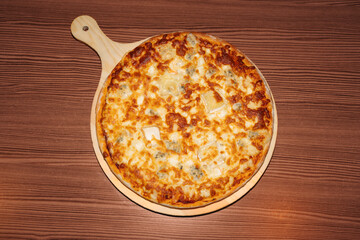 Cheese pizza on wooden background