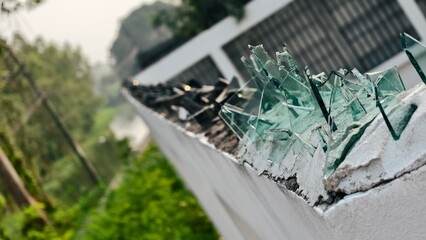 Sharp Glass Pieces Placed on Wall to Prevent Intrusion and Enhance Security in Urban Environment