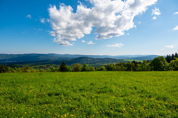 Obraz premium Ridge hiking trail from Javornik to Jested with scenic views into valleys and distant Jizera Mountains. Sunny summer day, peaceful nature and beautiful Czech landscape