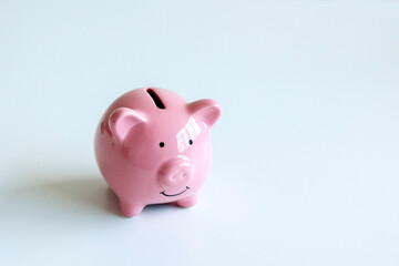 Cute pink piggy bank sits on a clean surface ready to collect coins and save money for future needs