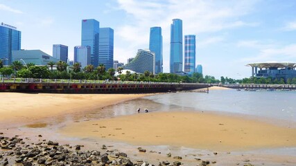 Morning at xiamen round island road seaside with people gathering shells
