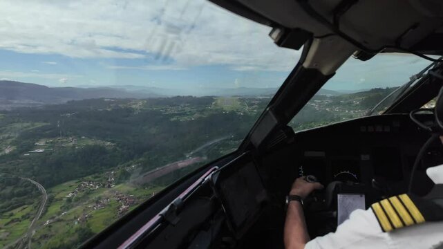 Caucasian Pilot (Captain Seat), flying manually a jet airplane during the intermediate approach to Vigo airport runway