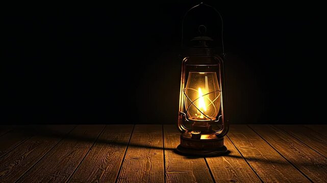 Lit vintage lantern casting light on wooden floor in dark room