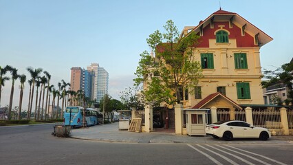 Several cars are parked on a quiet morning street in Ha Long City, Vietnam, Nov 15, 2024.