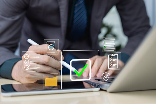 Businessman using digital pen laptop and tablet with online document approval system Secure data verification concept for digital workflows and business automation compiling checklists.