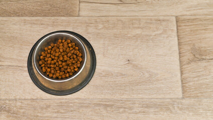 metal bowl with dog or cat food. Top view