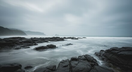 Obraz premium Moody Seascape Rocky Coastline Under a Cloudy Sky