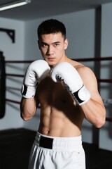 there is a man in a boxing ring posing for a picture
