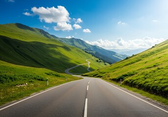 Naklejka premium Winding Mountain Road Through Lush Green Hills Under Clear Blue Sky