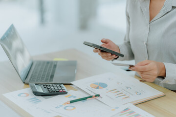Businesswoman Analyzing Financial Data with Mobile Phone